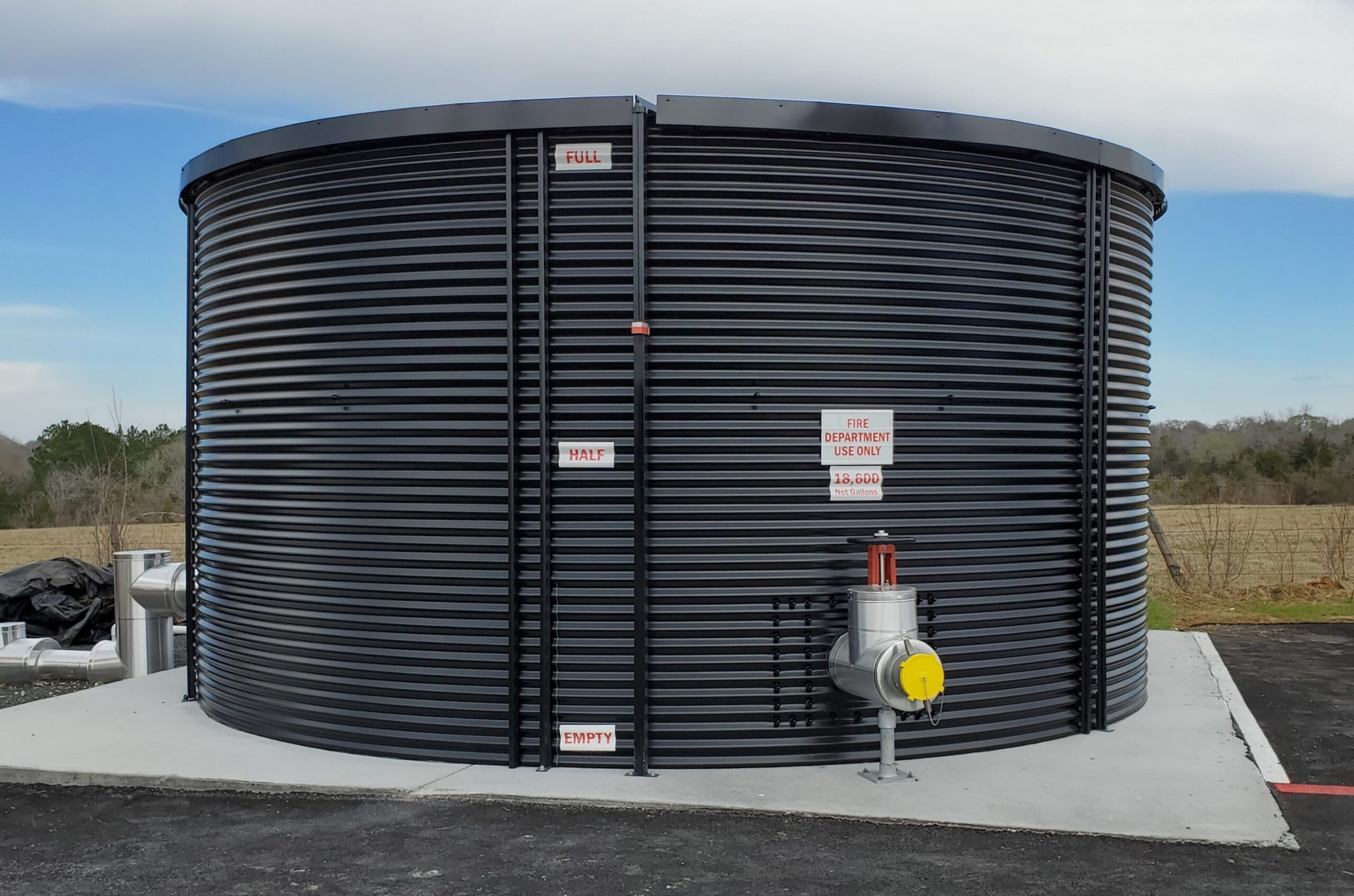 Steel fire protection water tank under a night sky